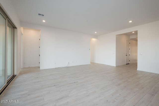 spare room with light hardwood / wood-style flooring