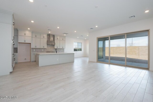 unfurnished living room featuring light hardwood / wood-style floors