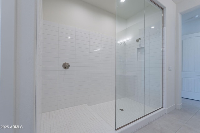 bathroom featuring a tile shower and tile patterned floors