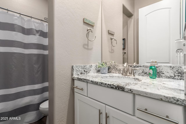 10542 W Electra Ln, Peoria, AZ 85383 - full bathroom featuring vanity, a textured wall, toilet, and a shower with shower curtain