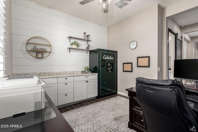 10542 W Electra Ln, Peoria, AZ 85383 - office with a ceiling fan, wood finished floors, wood walls, a barn door, and baseboards