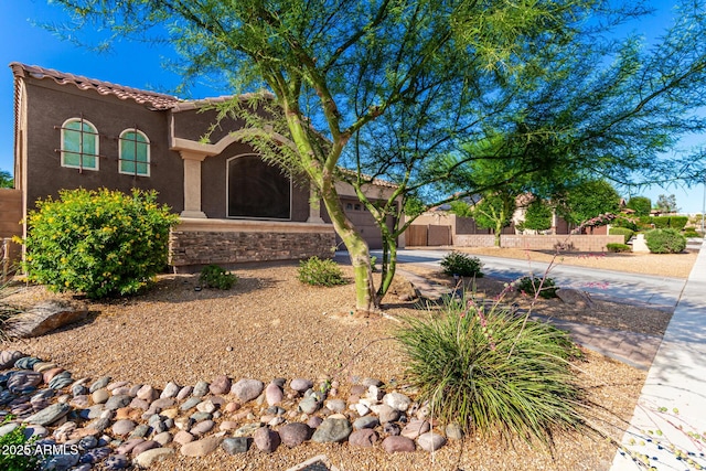 10542 W Electra Ln, Peoria, AZ 85383 - mediterranean / spanish-style house with driveway, stucco siding, stone siding, and an attached garage