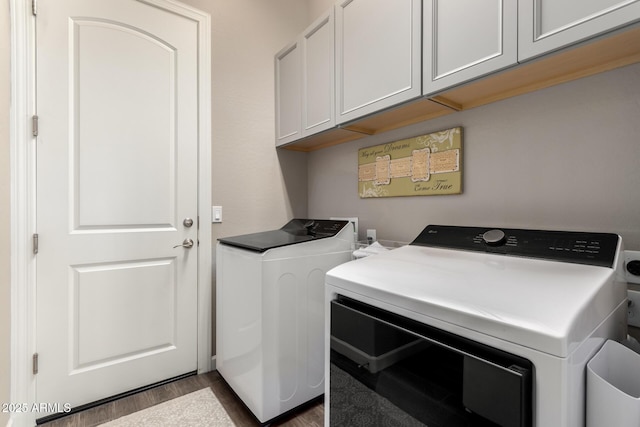 10542 W Electra Ln, Peoria, AZ 85383 - laundry area featuring washer and clothes dryer, cabinet space, and dark wood-type flooring