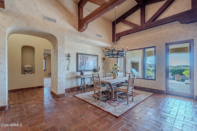 dining room with beamed ceiling, high vaulted ceiling, and an inviting chandelier