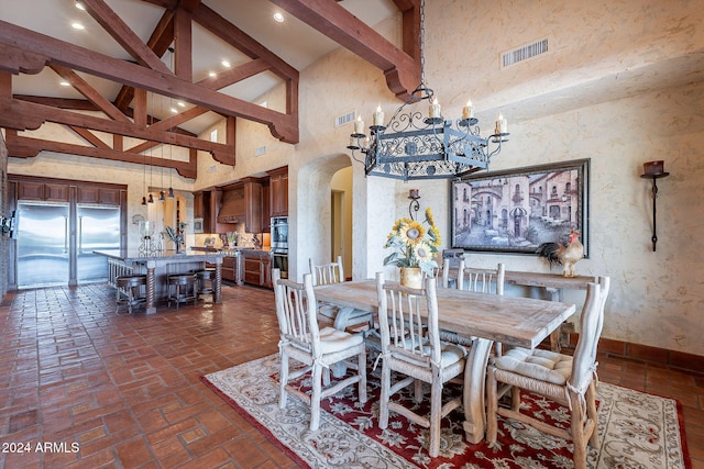 dining space featuring beamed ceiling and high vaulted ceiling