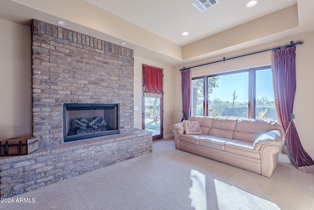 living room featuring a fireplace and light carpet