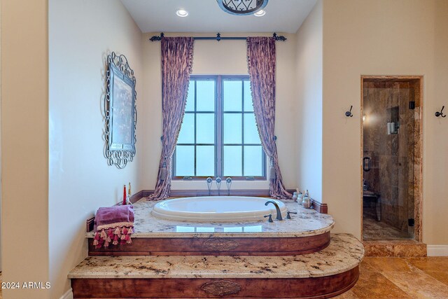 bathroom featuring shower with separate bathtub