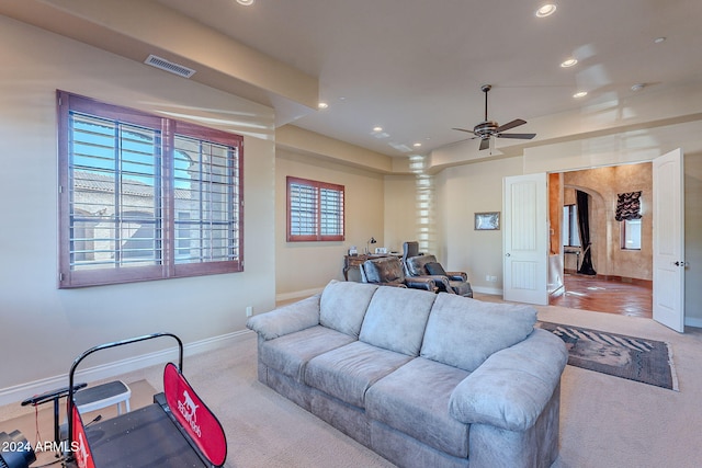 carpeted living room featuring ceiling fan and a healthy amount of sunlight