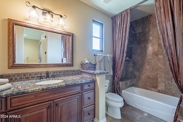 full bathroom featuring tile patterned floors, shower / tub combo with curtain, vanity, and toilet