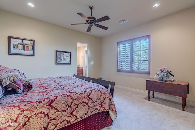 carpeted bedroom featuring ceiling fan and ensuite bath