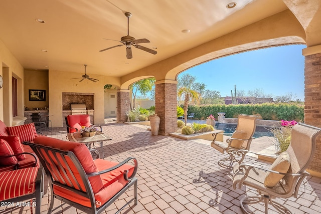 view of patio / terrace featuring ceiling fan and an outdoor kitchen