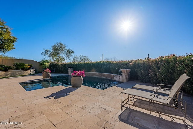 view of pool featuring pool water feature and a patio area