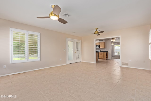 unfurnished living room with ceiling fan and light tile patterned flooring