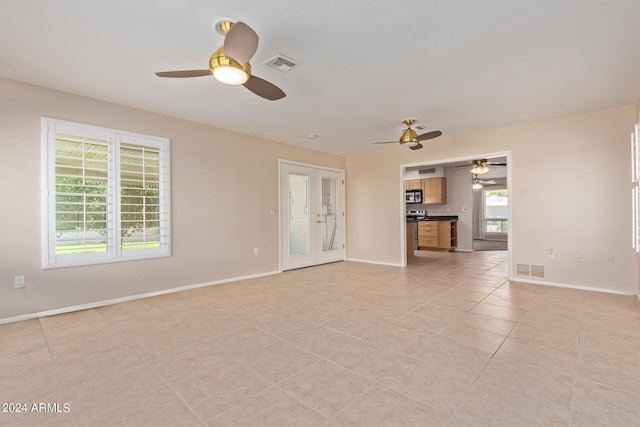 unfurnished living room with visible vents, baseboards, and light tile patterned floors