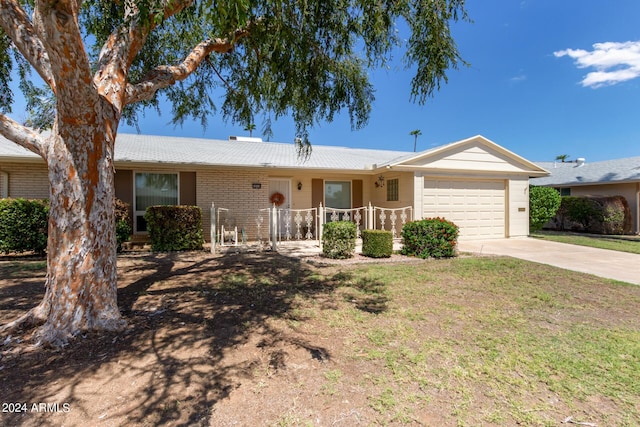 ranch-style house featuring driveway, brick siding, an attached garage, and a front yard