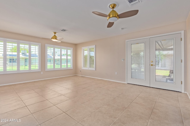 unfurnished room featuring ceiling fan, light tile patterned floors, and french doors