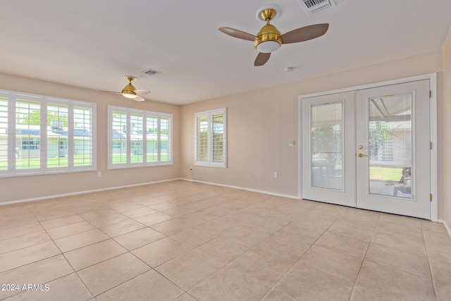 spare room with light tile patterned floors, visible vents, and french doors