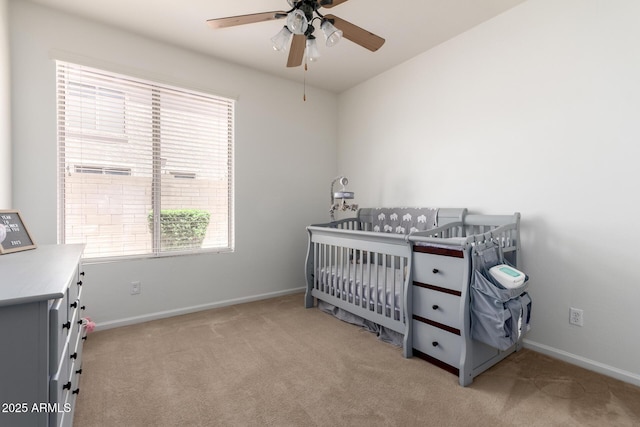 7231 W Lone Cactus Dr, Glendale, AZ 85308 - bedroom featuring light carpet, baseboards, a nursery area, and a ceiling fan
