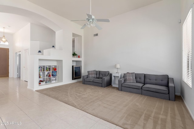 7231 W Lone Cactus Dr, Glendale, AZ 85308 - living area featuring built in features, high vaulted ceiling, light tile patterned floors, baseboards, and ceiling fan