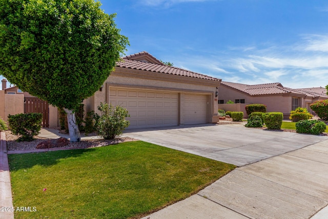 7231 W Lone Cactus Dr, Glendale, AZ 85308 - view of front of home with an attached garage, a tile roof, driveway, and stucco siding
