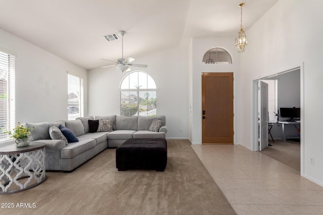 7231 W Lone Cactus Dr, Glendale, AZ 85308 - living area with light tile patterned flooring, baseboards, a ceiling fan, high vaulted ceiling, and light carpet