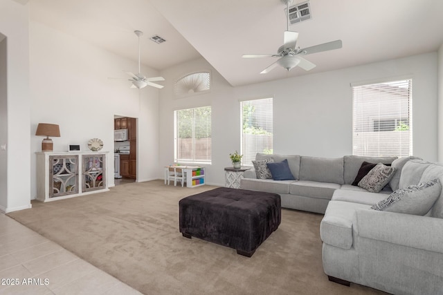 7231 W Lone Cactus Dr, Glendale, AZ 85308 - tiled living area with ceiling fan, carpet flooring, baseboards, and vaulted ceiling