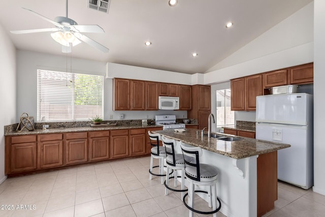 7231 W Lone Cactus Dr, Glendale, AZ 85308 - kitchen featuring white appliances, a sink, ceiling fan, brown cabinets, and vaulted ceiling