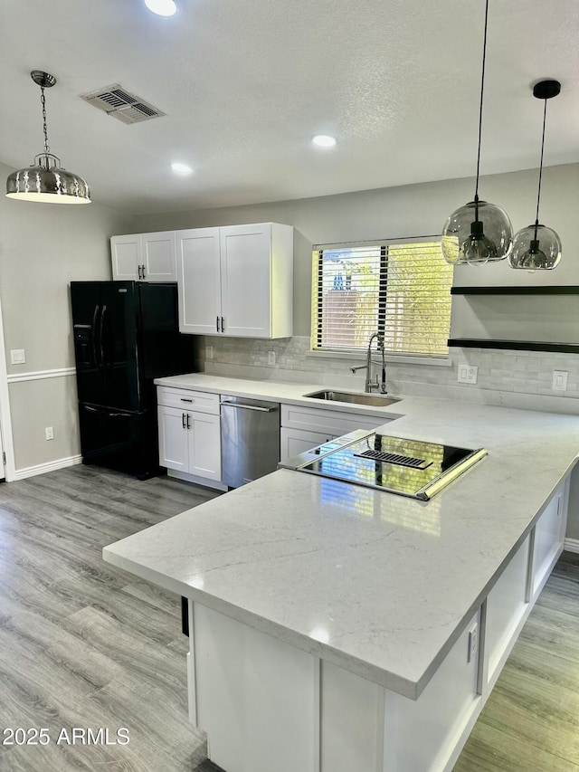 2138 E Williams Dr, Phoenix, AZ 85024 - kitchen featuring black appliances, a sink, a peninsula, white cabinets, and light wood-style floors