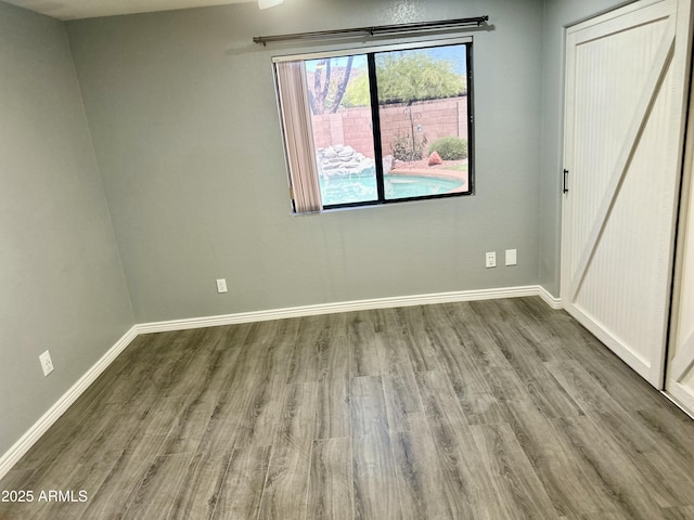 2138 E Williams Dr, Phoenix, AZ 85024 - unfurnished bedroom featuring wood finished floors and baseboards
