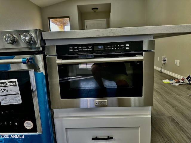 2138 E Williams Dr, Phoenix, AZ 85024 - kitchen view of oven, wood finished floors, and baseboards