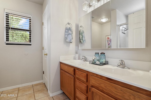 bathroom featuring double vanity, a shower, a sink, and tile patterned floors