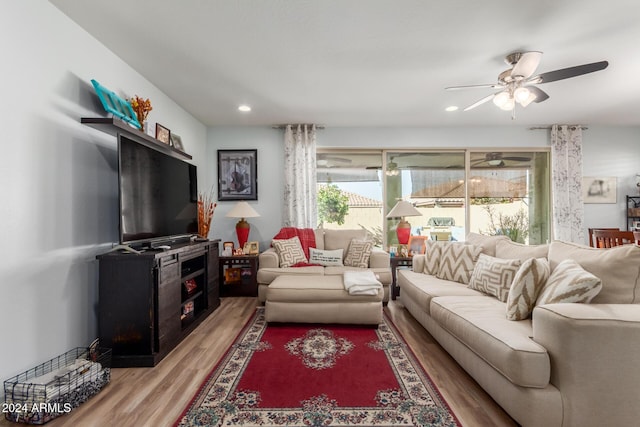 living room featuring ceiling fan and light hardwood / wood-style floors