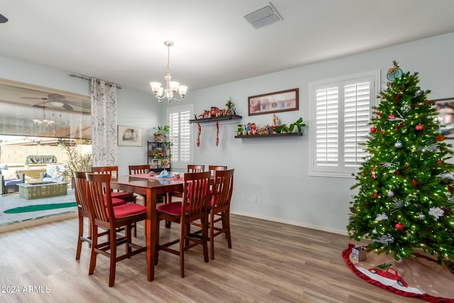 dining space with a chandelier and hardwood / wood-style floors