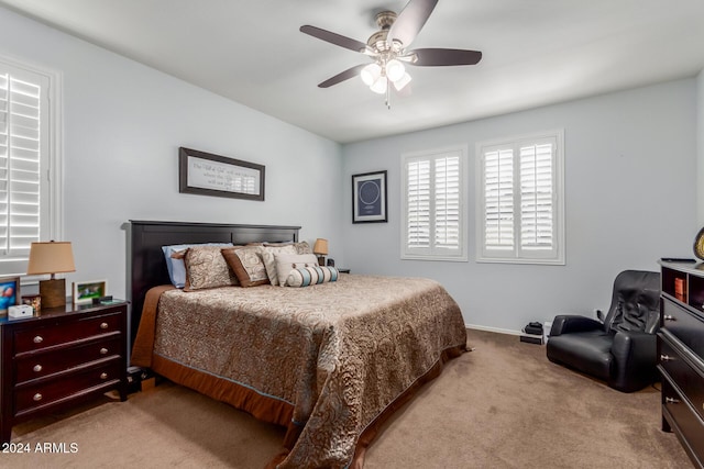 bedroom featuring ceiling fan and light carpet