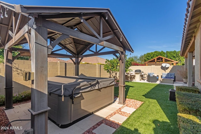 view of patio with a gazebo, exterior kitchen, and a hot tub