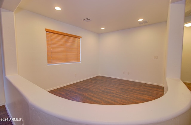 unfurnished room featuring dark hardwood / wood-style flooring