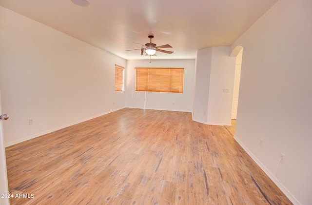 spare room with light wood-type flooring and ceiling fan