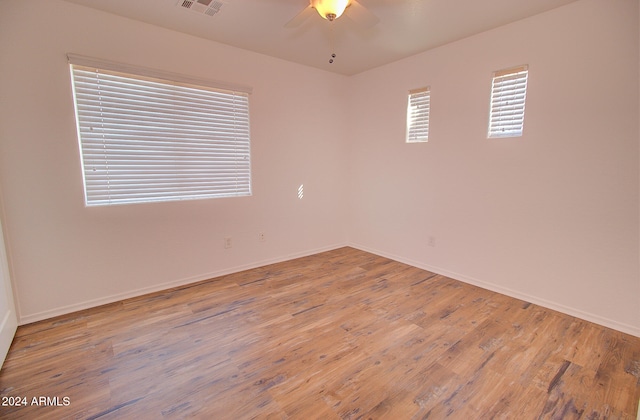 empty room featuring hardwood / wood-style flooring and ceiling fan