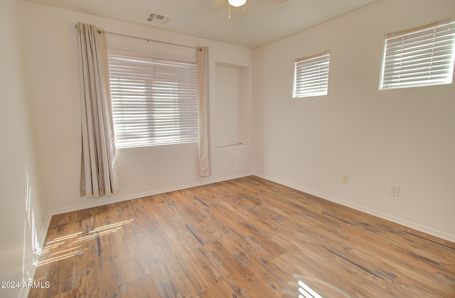 empty room featuring ceiling fan and hardwood / wood-style floors