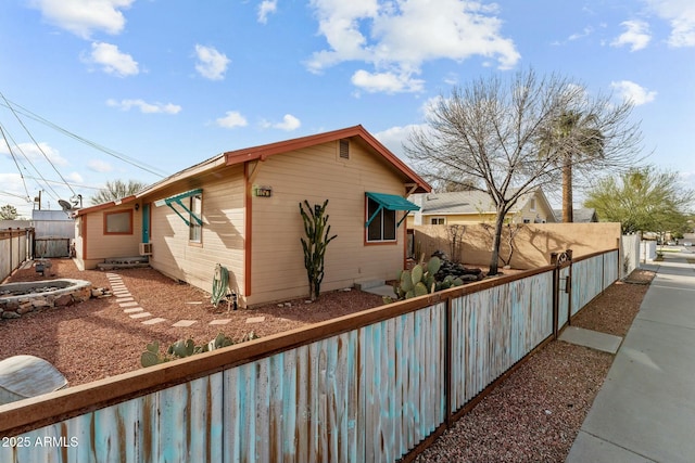 view of side of home featuring a fenced backyard