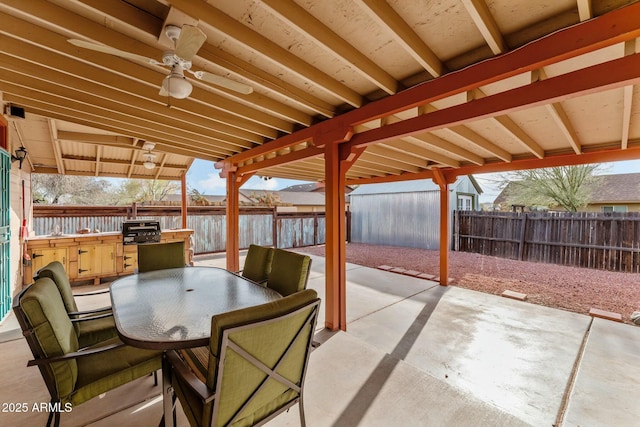 view of patio / terrace with outdoor dining area, area for grilling, a fenced backyard, and a ceiling fan