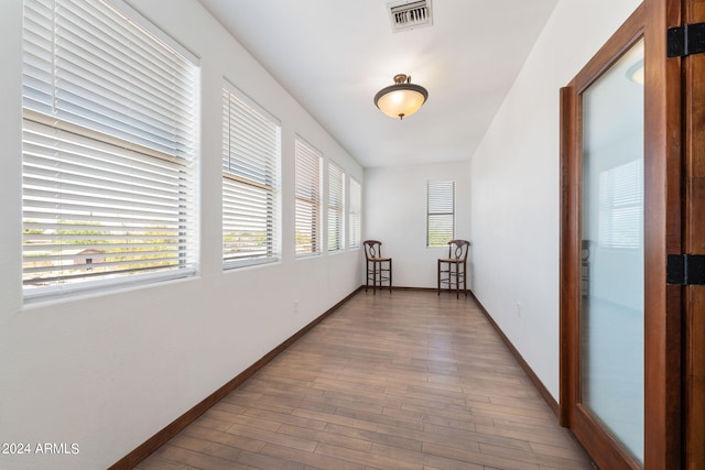 hallway with hardwood / wood-style flooring