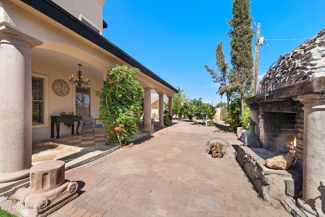 view of patio / terrace featuring an outdoor stone fireplace