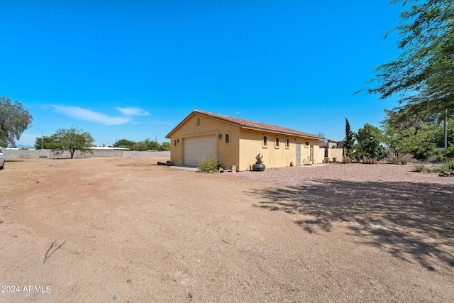 view of side of property with a garage