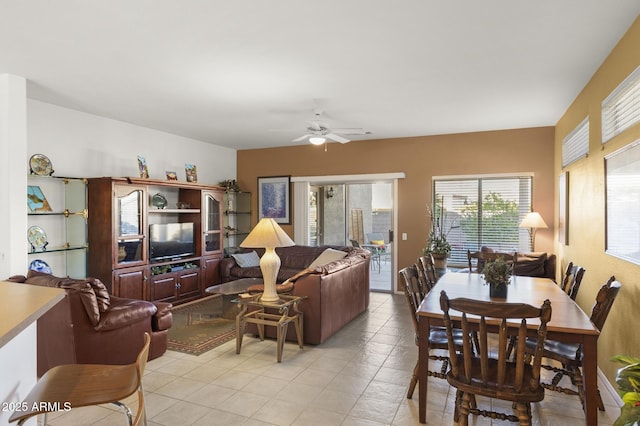 living area featuring light tile patterned floors and ceiling fan