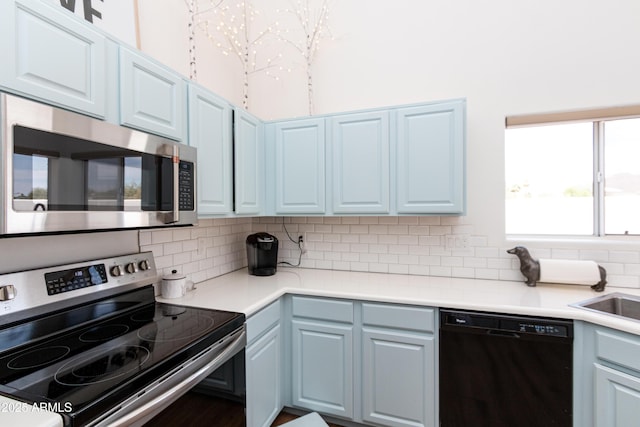 9791 N 118th Way, Scottsdale, AZ 85259 - kitchen with appliances with stainless steel finishes, tasteful backsplash, blue cabinetry, and light countertops