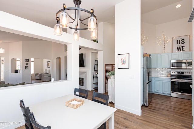 9791 N 118th Way, Scottsdale, AZ 85259 - dining area featuring a chandelier, light wood-style floors, a high ceiling, and recessed lighting