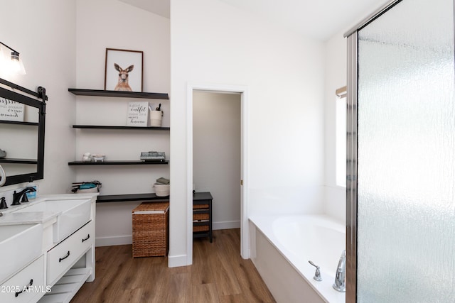 9791 N 118th Way, Scottsdale, AZ 85259 - bathroom featuring wood finished floors, a bath, double vanity, and a stall shower