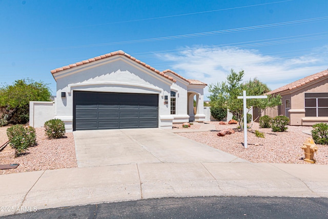 9791 N 118th Way, Scottsdale, AZ 85259 - mediterranean / spanish house featuring a tile roof, stucco siding, driveway, and an attached garage