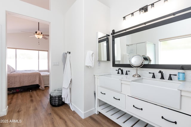 9791 N 118th Way, Scottsdale, AZ 85259 - full bath featuring double vanity, wood finished floors, a ceiling fan, a shower stall, and connected bathroom